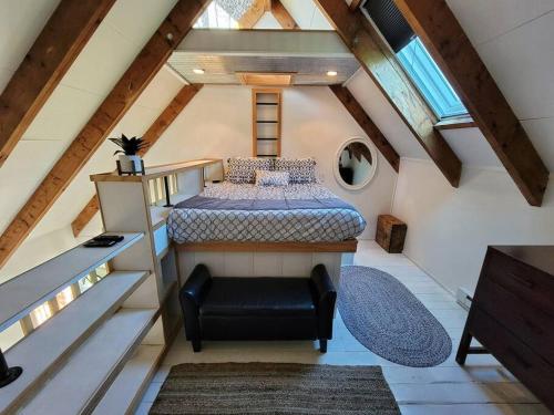 a attic room with a bed and a staircase at The Davis Loft in Davis