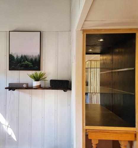 a room with a glass door with a plant on a shelf at The Davis Loft in Davis