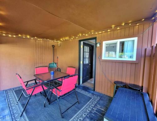 a patio with a table and chairs and a window at The Davis Loft in Davis