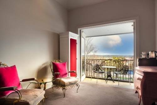 a living room with a door open to a balcony at Hotel Frangos in Daylesford