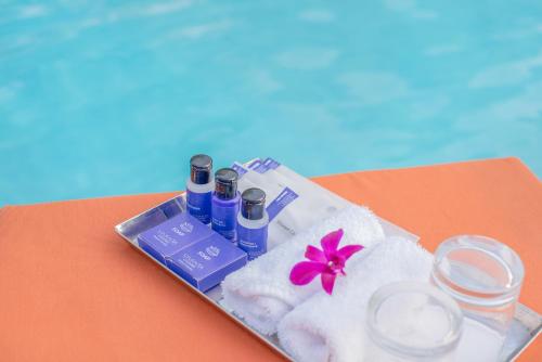a tray with spa products and a flower on a table at Vivanta Colombo, Airport Garden in Negombo