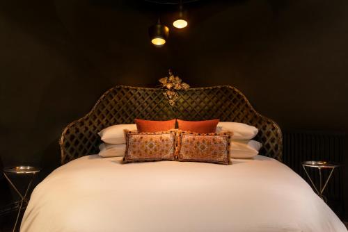 a bedroom with a bed with pillows on it at Hotel Frangos in Daylesford