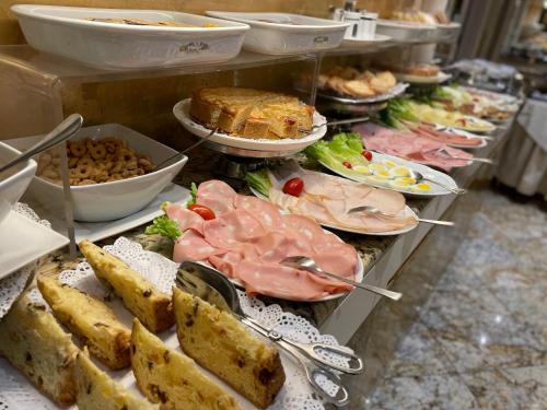 a buffet filled with lots of different types of food at Hotel Wagner in Milan