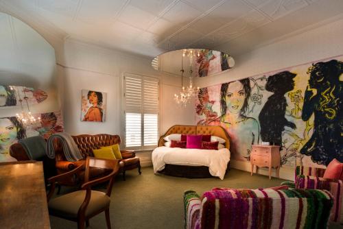 a bedroom with a bed and a large painting on the wall at Hotel Frangos in Daylesford