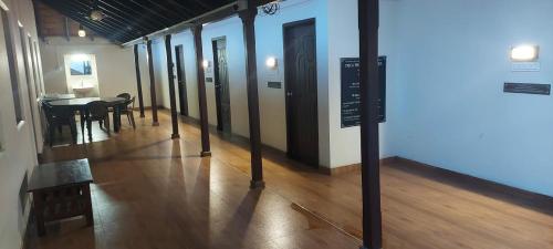 a hallway with a table and chairs in a room at YMCA PROGRAM CENTRE in Salem