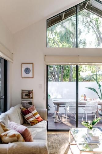 a living room with a couch and a glass table at The Villa Margaret River in Margaret River Town