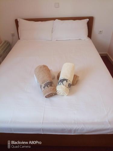 two towels sitting on top of a bed at Sardinia lux house in Sardínia