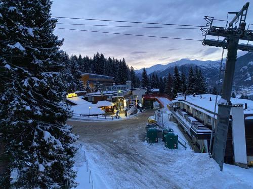 a ski resort in the mountains with snow on the ground at La Tana del Gufetto in Marilleva