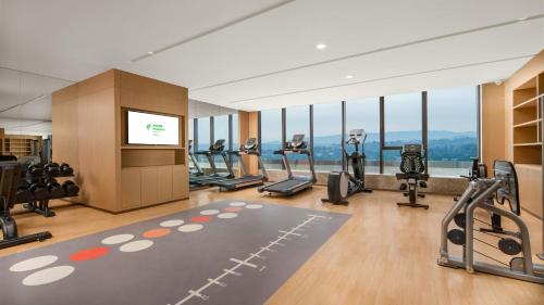 a gym with treadmills and cardio equipment in a building at Holiday Inn Luzhou Longjian by IHG in Luzhou