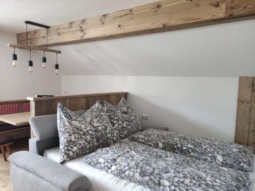 a bedroom with a bed and a desk and a table at Bauernhof - Appartement beim Zefferer in Schladming