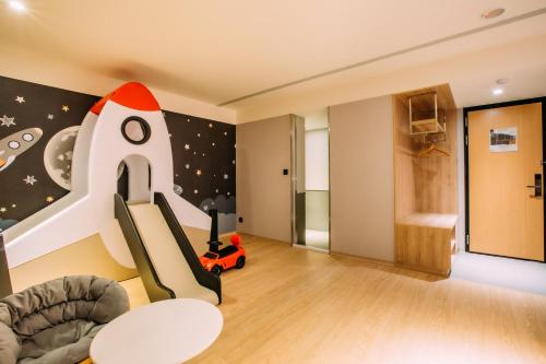a childs room with a rocket wall mural at Mega Hotel in Chiayi City