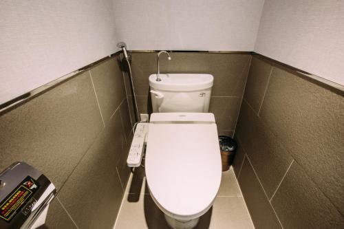 a small bathroom with a white toilet in a stall at Mega Hotel in Chiayi City