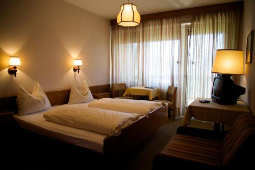 En eller flere senger på et rom på Hotel Tannerhof