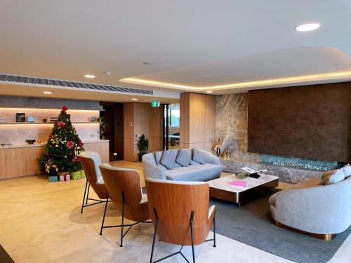 a living room with a christmas tree and a couch at Skygarden Luxury Condo in Glen Waverley