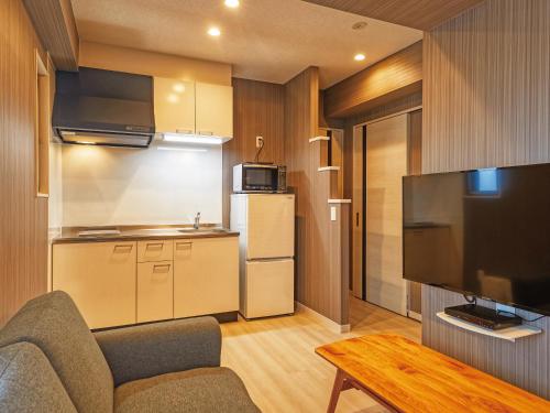 a living room with a couch and a kitchen at Terrace Resort Mihama Chatan in Chatan