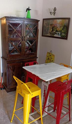 a dining room with a table and four chairs at Swaru Luxurious Villa in Tamhini Ghat & Kolad Rafting in Nizāmpur