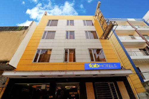 a yellow building with a blue sign on it at FabHotel Baba Residency in New Delhi