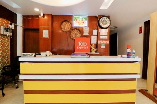 a yellow and white counter in a restaurant at FabHotel Baba Residency in New Delhi