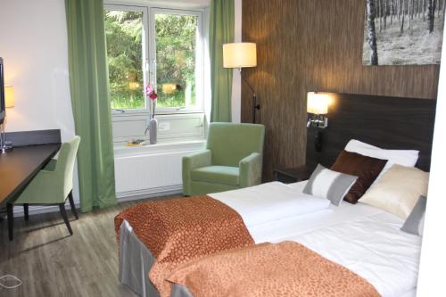 מיטה או מיטות בחדר ב-Sørmarka Konferansehotell