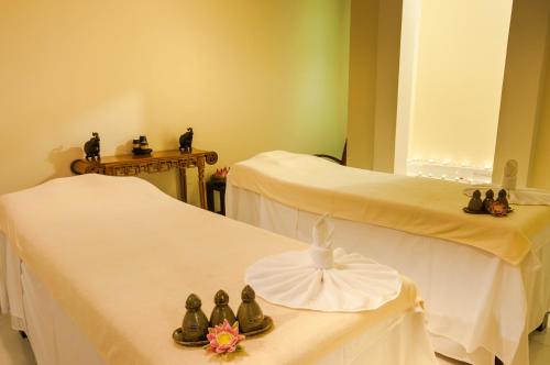 a room with two beds with shoes on them at Saem Siemreap Hotel in Siem Reap