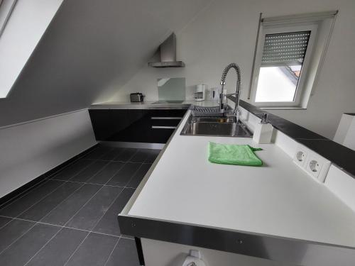 a kitchen with a white counter and a sink at COSYLOFT APARTMENT in Boevange-sur-Attert