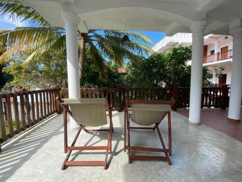 two chairs and a table on a porch at Unawatuna Nor Lanka Hotel in Unawatuna