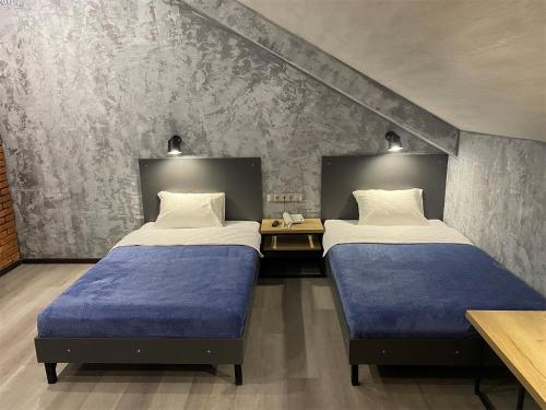 2 camas en una habitación con pared en Апарт-отель Attic, en Zabaykal'sk