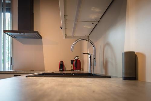 a kitchen counter with a sink and a faucet at Oud Gemeentehuis in Poelkapelle