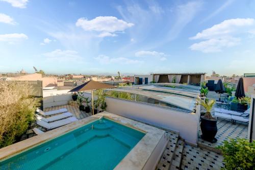 a swimming pool on the roof of a building at Riad Amina in Marrakesh