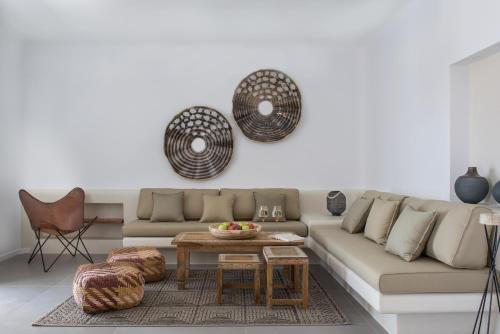 a living room with a couch and a table at White & Co Exclusive Island Villas in Pirgos