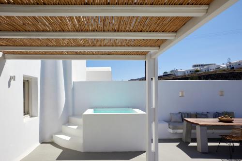 a room with white walls and a wooden ceiling at White & Co Exclusive Island Villas in Pirgos