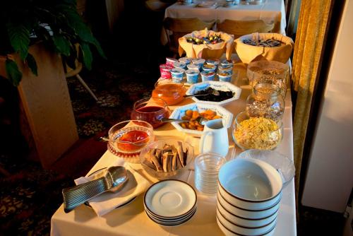a table topped with plates and bowls of food at Hotel Tannerhof in Merano