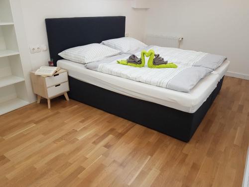 a bed with green shoes on top of it at Ferienwohnung Rainer in Fieberbrunn