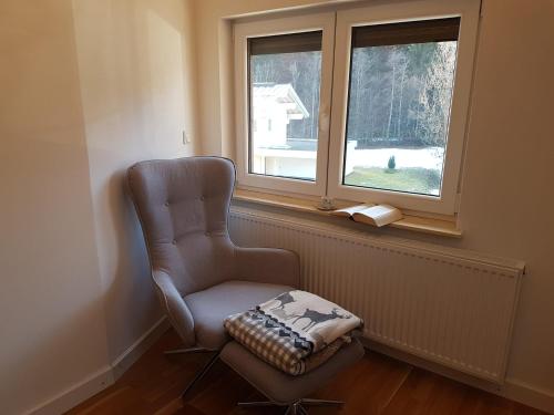 a chair sitting in a room with a window at Ferienwohnung Rainer in Fieberbrunn