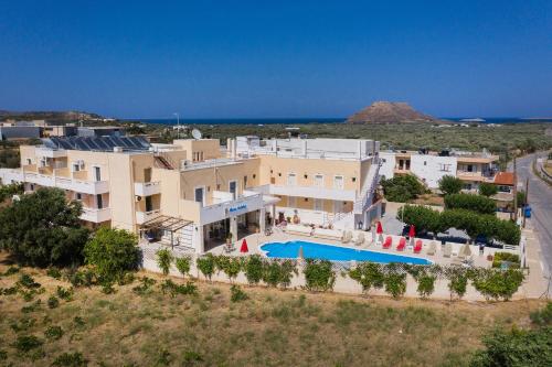 an aerial view of a building with a swimming pool at Hiona Holiday Hotel in Palekastron