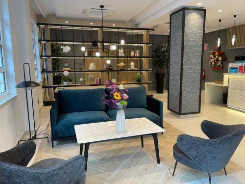 a living room with a couch and a table and chairs at Hotel Don Rodrigo in Palencia