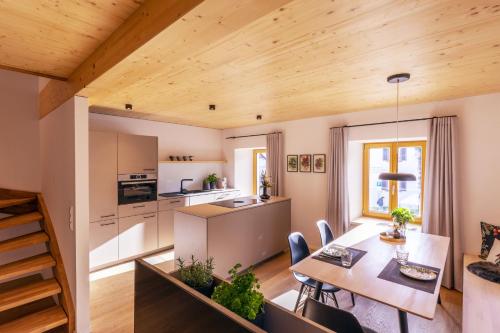 a kitchen and living room with a table and chairs at Apartments Bären in Elzach