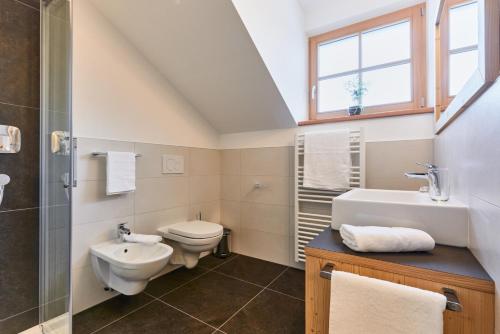 a bathroom with a sink toilet and a shower at Huberhof in San Lorenzo di Sebato