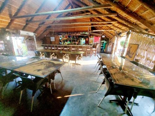 a room with tables and chairs in a building at Sundown Lodge in Komatipoort