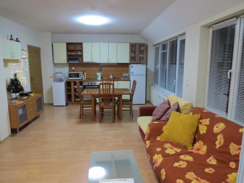 a living room with a couch and a table at Panoramic Apartment 301 in Eagle Rock Complex in Beli Iskar