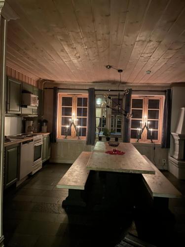 a kitchen with a table in the middle of it at Tinden in Hemsedal
