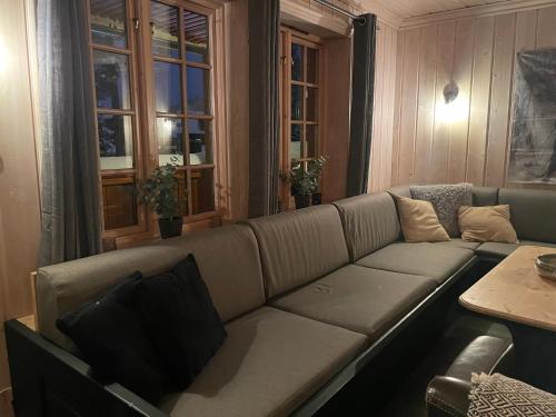 a living room with a couch and a table at Tinden in Hemsedal