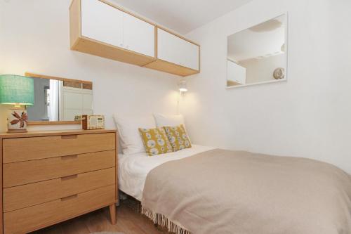 Un dormitorio con una cama, una cómoda y un espejo. en City Centre Haven Apartments, en Edimburgo