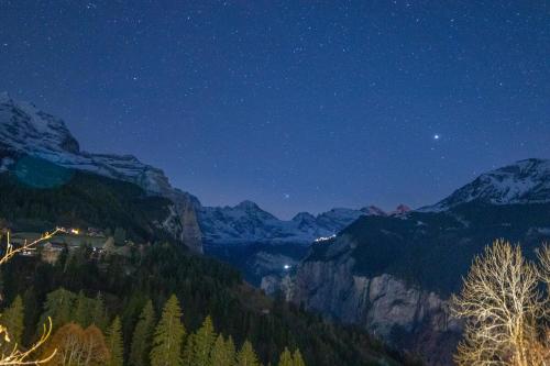 a night view of a valley in the mountains at Chalet Aargovia in Wengen