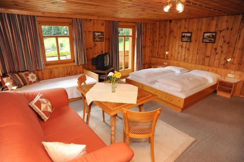 1 dormitorio con 2 camas, sofá y mesa en Haus Schönlechner, en Gaschurn