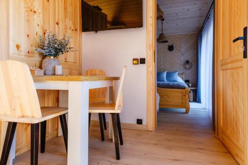 a dining room with a table and chairs at Domek Leśny in Zakopane