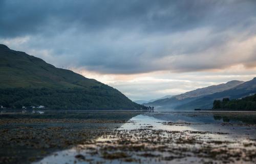 a large body of water with mountains in the background at Arrochar Hotel 'A Bespoke Hotel' in Arrochar
