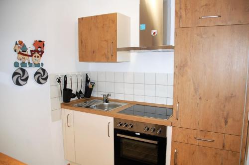 a small kitchen with a sink and a stove at Ferienwohnung mit Aussicht in Enzklösterle