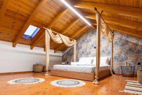 a bedroom with a canopy bed and a wooden ceiling at Eagle's Nest City Apartments in Aigio