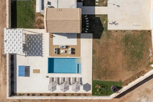 an overhead view of a building with a swimming pool at Evaero Villas I, II, III, IV - an ever-so inviting escape, By ThinkVilla in Sfakaki
